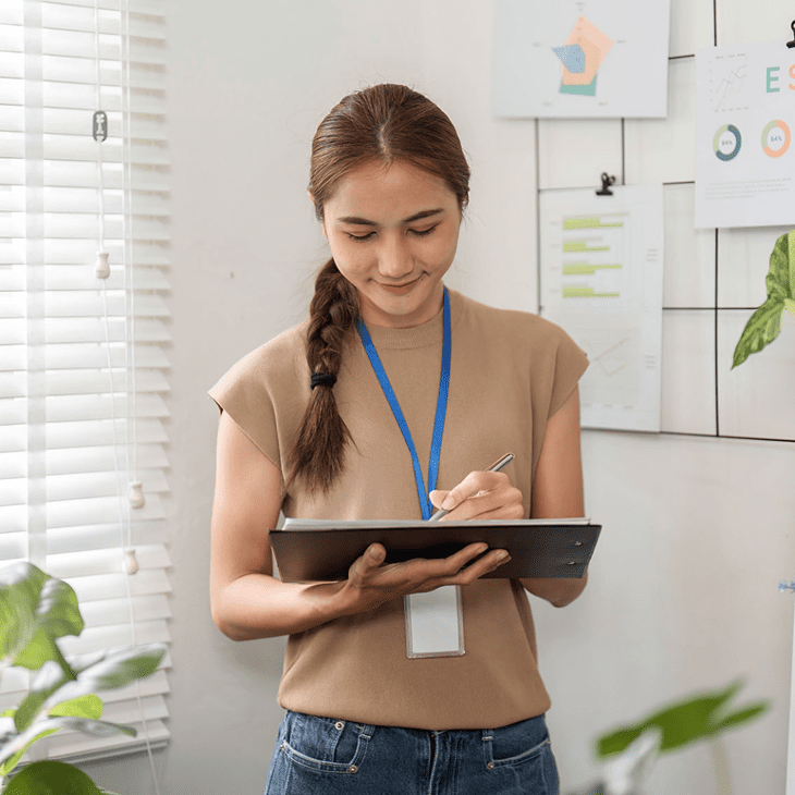 Office worker taking notes by window